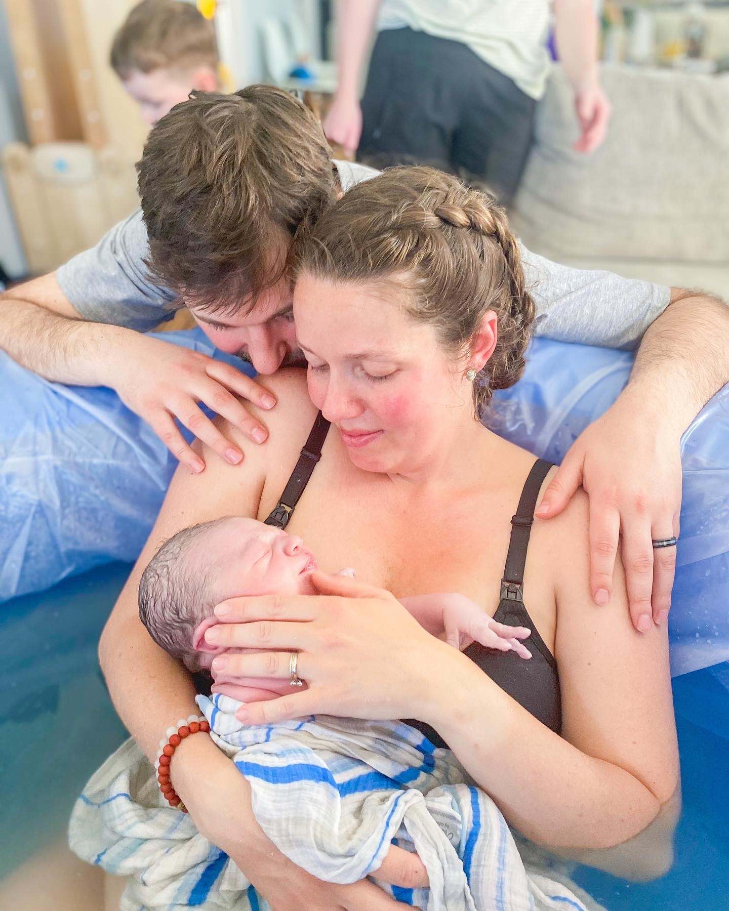 A mother resting in the water during a peaceful birth
