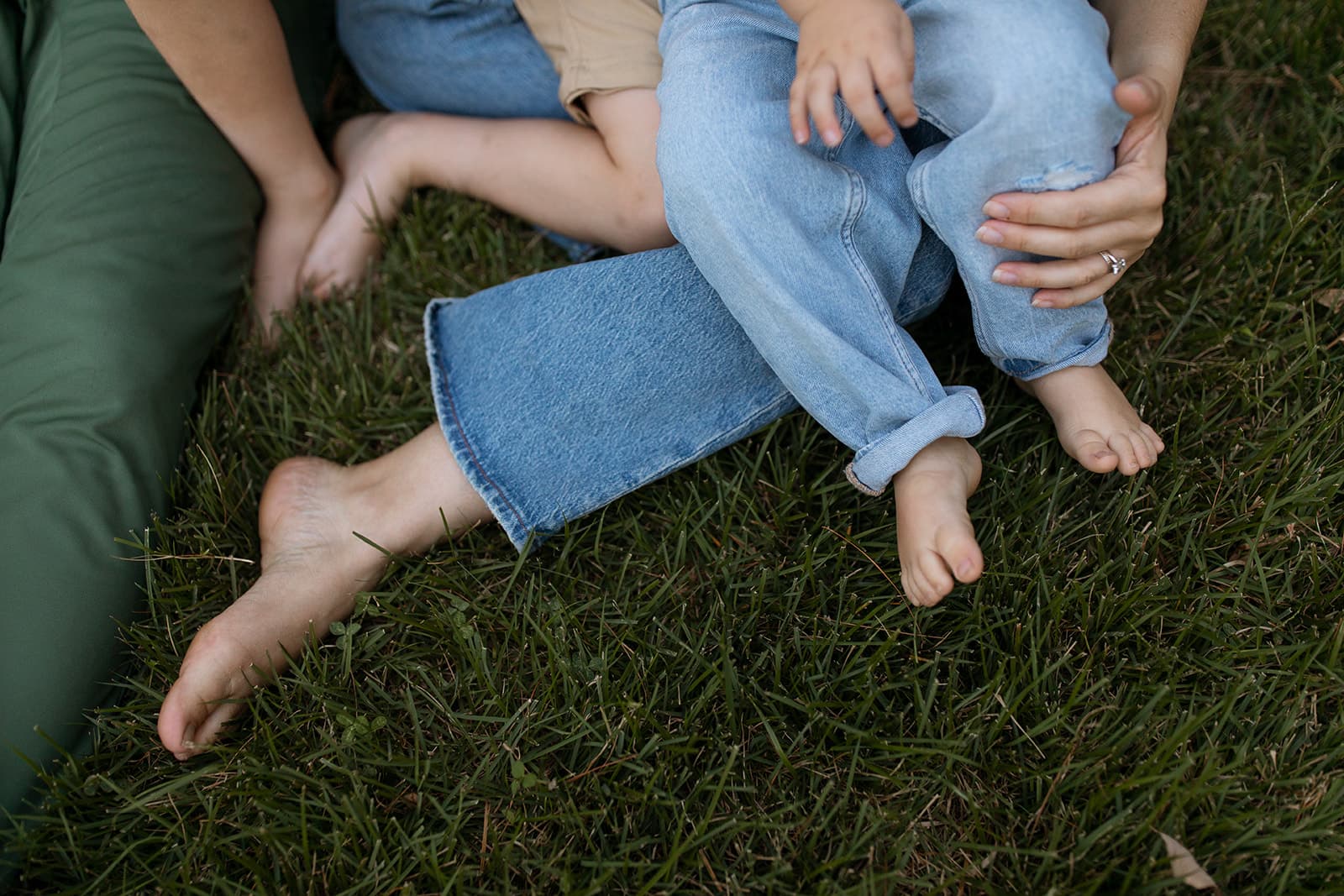 A mother and child resting together in the grass