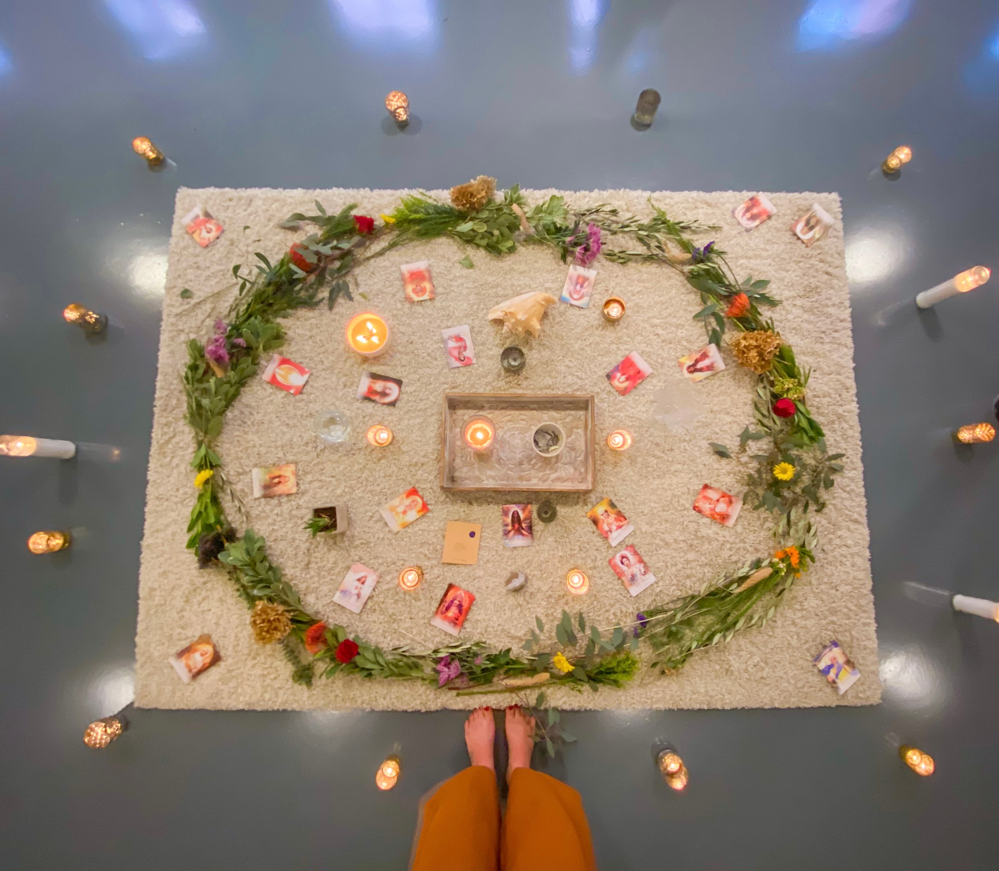 A ritual altar arranged with candles and flowers