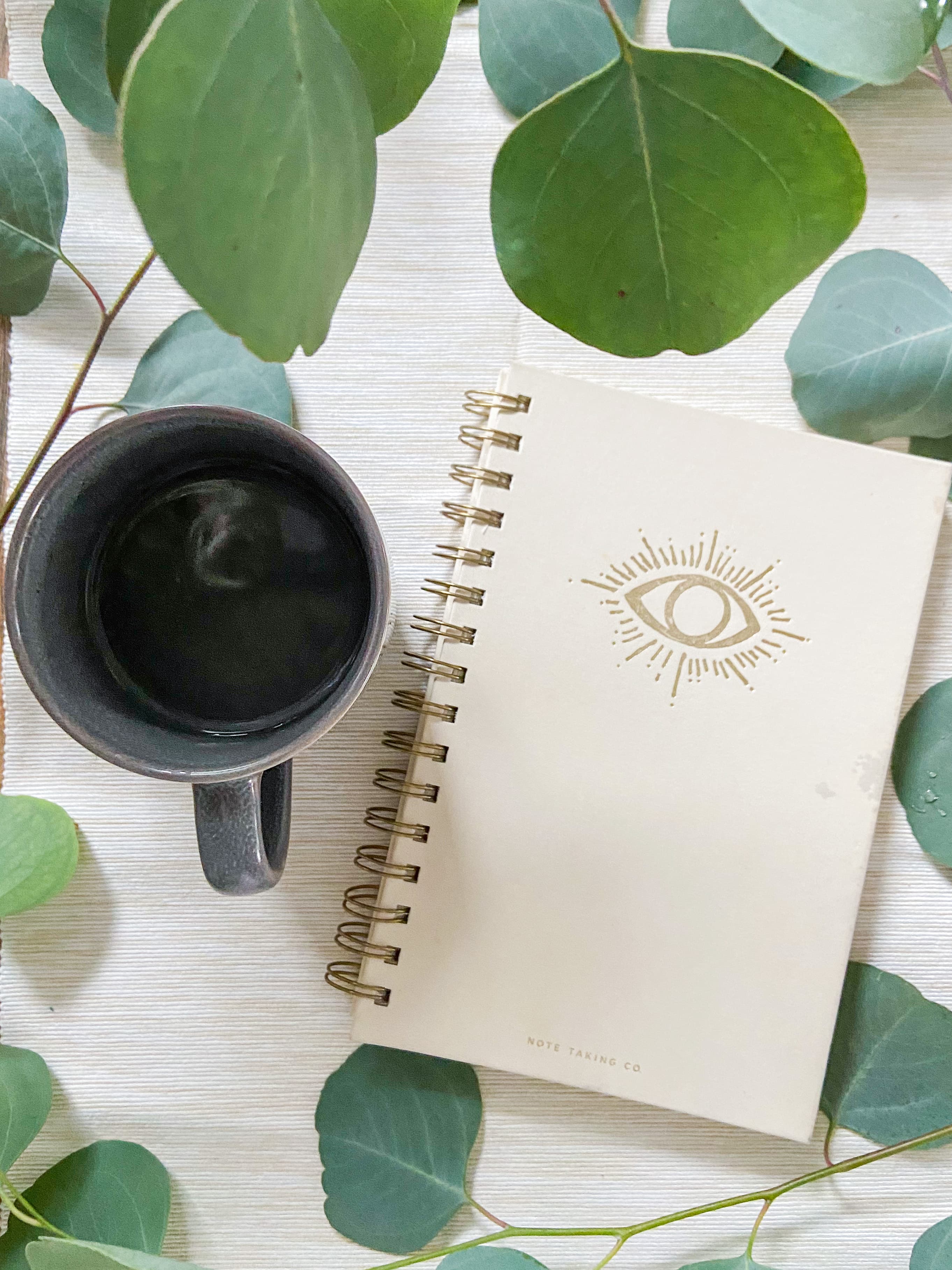 A journal and coffee resting in a quiet morning ritual